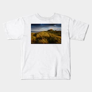 Bamburgh Castle at sunset Kids T-Shirt